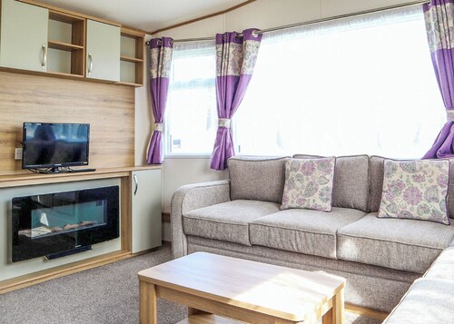 Comfortable modern 12ft-wide caravan with one double and two twin.