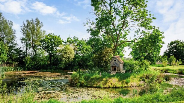 A rustic wooden structure near a pond surrounded by lush greenery. - 3 bedroom accommodation in Flaxton (Flaxton)