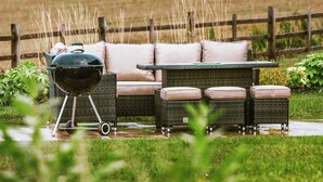 A patio with a grill, wicker furniture, and a cushioned sofa. - Three bed lodge with two king-size beds and one twin (king by arrangement). (Nottingham)