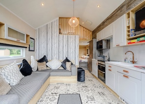 A modern kitchen with white cabinets, a built-in oven, and a microwave. - 1 bedroom accommodation in Newcastleton, (Newcastleton,)