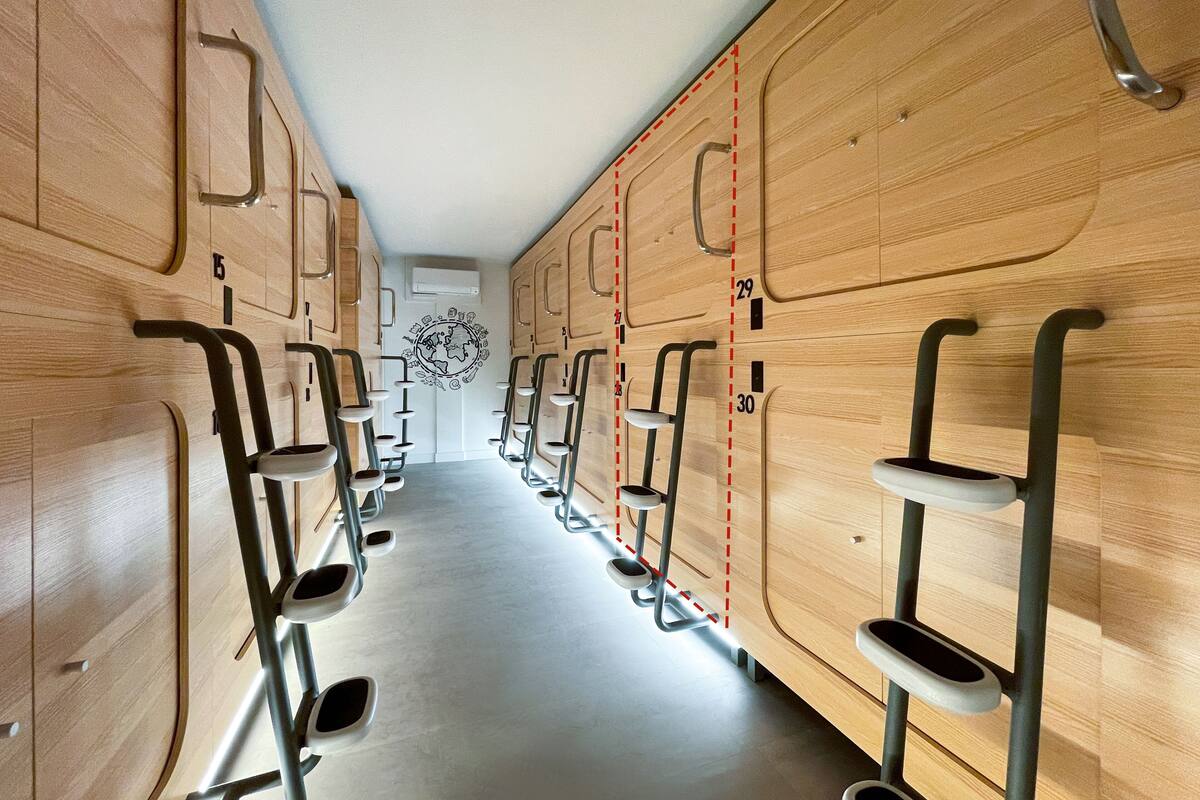 A row of wooden lockers with metal steps and handles, numbered from 1 to 30.