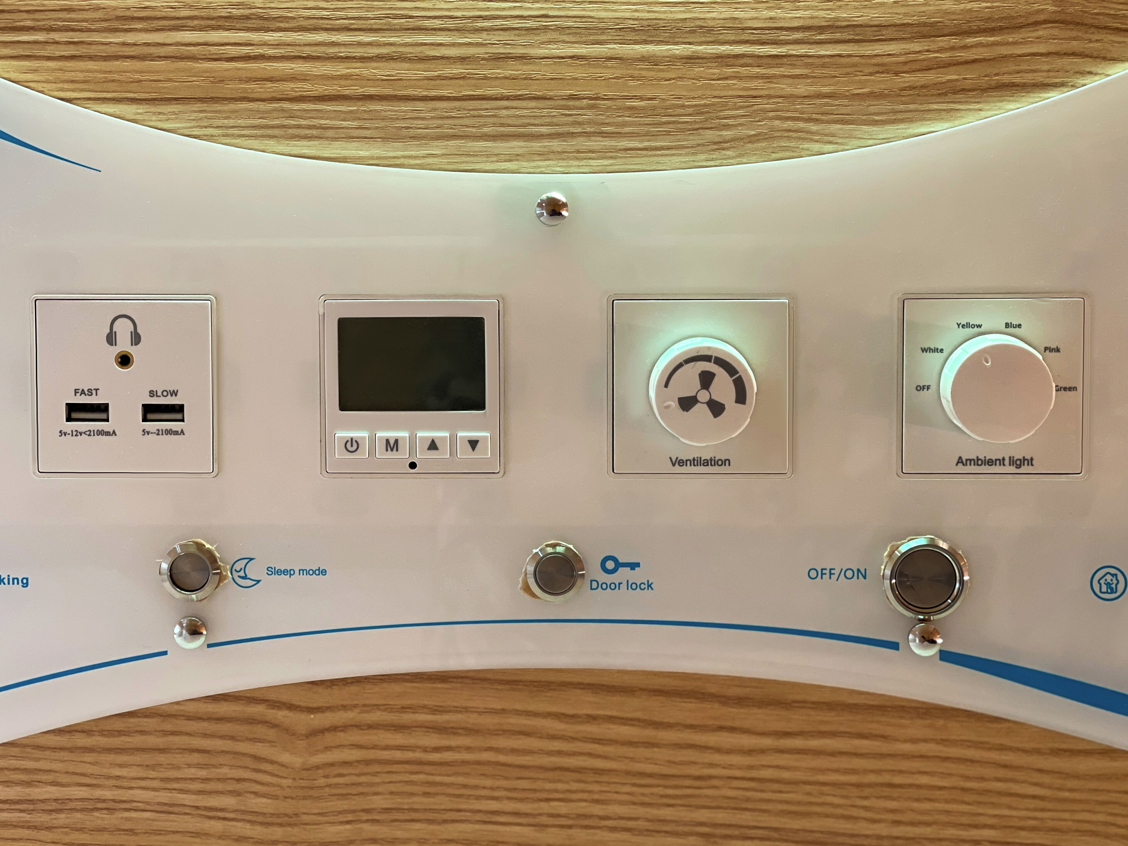 Un panel de control con ventilación, luz ambiental y funciones de cierre de puerta.