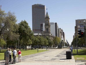 Stroll through the vibrant city square, surrounded by a mix of historic and modern architecture.