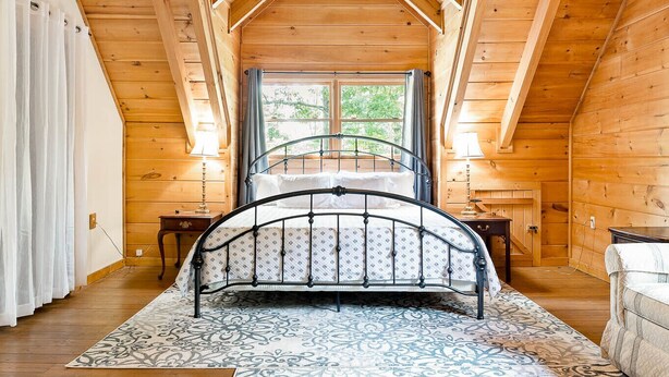 A bedroom with a wooden ceiling, a bed, a window, and a nightstand. - 🏕️  Angels Cabin, Firepit, Pool Table, LKT Mountain - Chattanooga Dwtn15 min!  (Lookout Mountain)