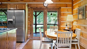 A wooden cabin interior with a kitchen, dining area, and large windows. - 🏕️  Angels Cabin, Firepit, Pool Table, LKT Mountain - Chattanooga Dwtn15 min!  (Lookout Mountain)