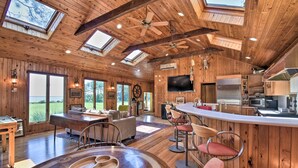 A spacious wooden cabin with a large dining area, bar, and kitchen. - Spacious Cheriton Home: 8 Mi to Cape Charles! (Cheriton)