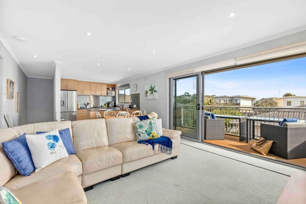 🌊 Open-plan living and dining area flowing onto a spacious outdoor deck
