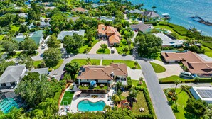 An aerial view of a residential area with houses, a swimming pool, and a marina. - 8 BR Heated Pool & Soccer Field (Largo)
