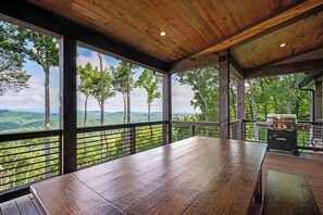 A wooden deck with a view of a forest and mountains. - Daybreak Ridge - Blue Ridge, GA. (Blue Ridge)