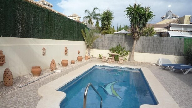 A rectangular swimming pool with a tiled edge, surrounded by a stone patio. - Villa 'Nala' with Pool and Wi-Fi (Mazarrón)