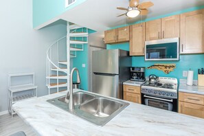 A kitchen with a stainless steel sink, a refrigerator, a stove, and a microwave. - Aint Dat A Beach II - 2BR Upper Unit on the 2nd Row (North Topsail Beach)