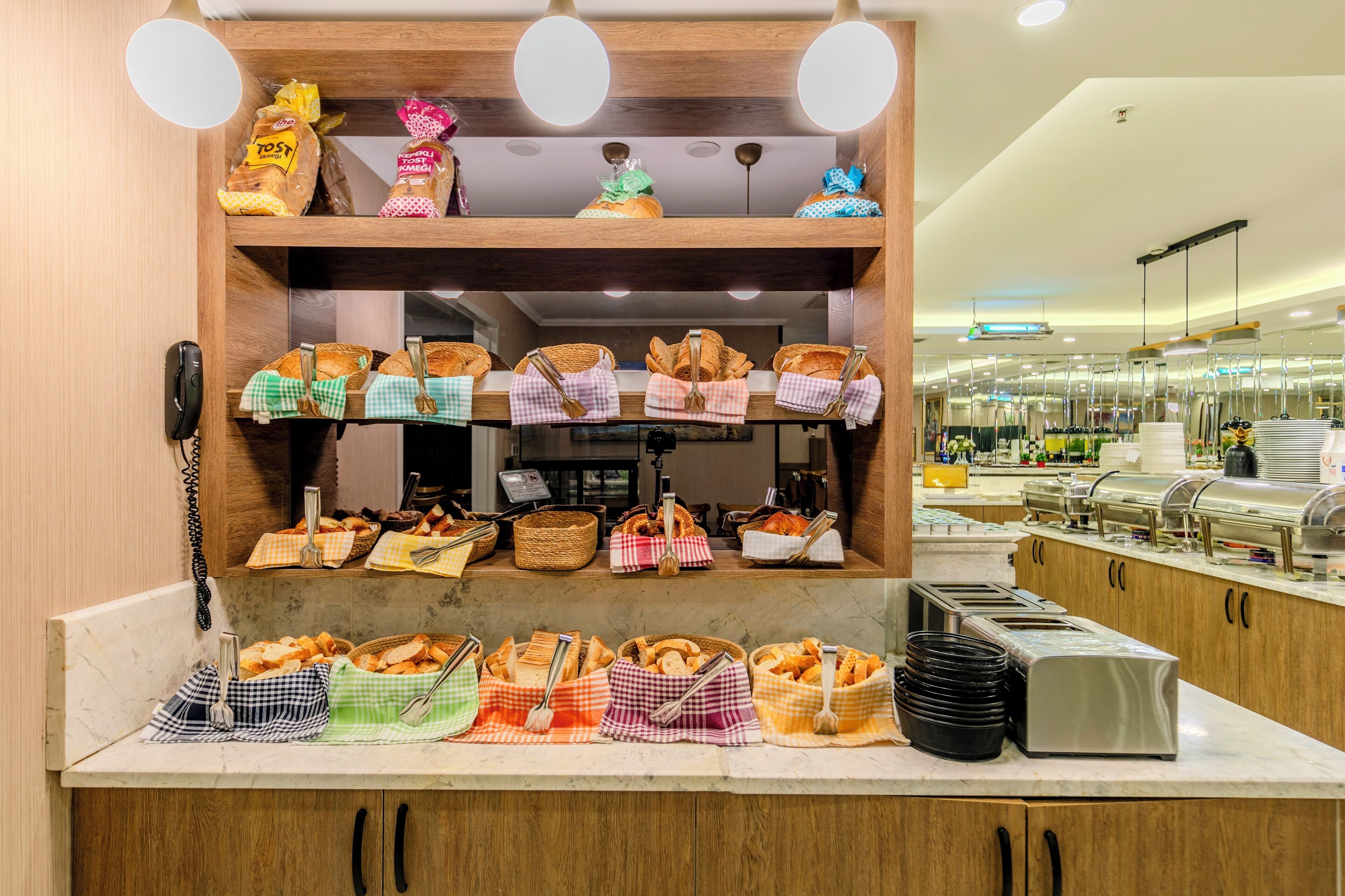 A buffet area with various food items and serving utensils.