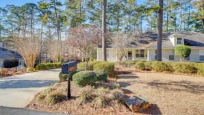A residential street with houses, a mailbox, and a well-maintained lawn. - Lakefront McCormick Gem: Deck & Golf Course Views (McCormick)