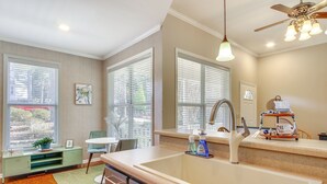 A kitchen with a large island, a sink, and a window with blinds. - Lakefront McCormick Gem: Deck & Golf Course Views (McCormick)
