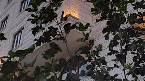 Un edificio de varios pisos con un letrero rojo destacado en la fachada.
