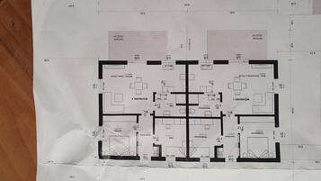 A floor plan of a hotel with multiple rooms, including a kitchen, dining area, and a living room.