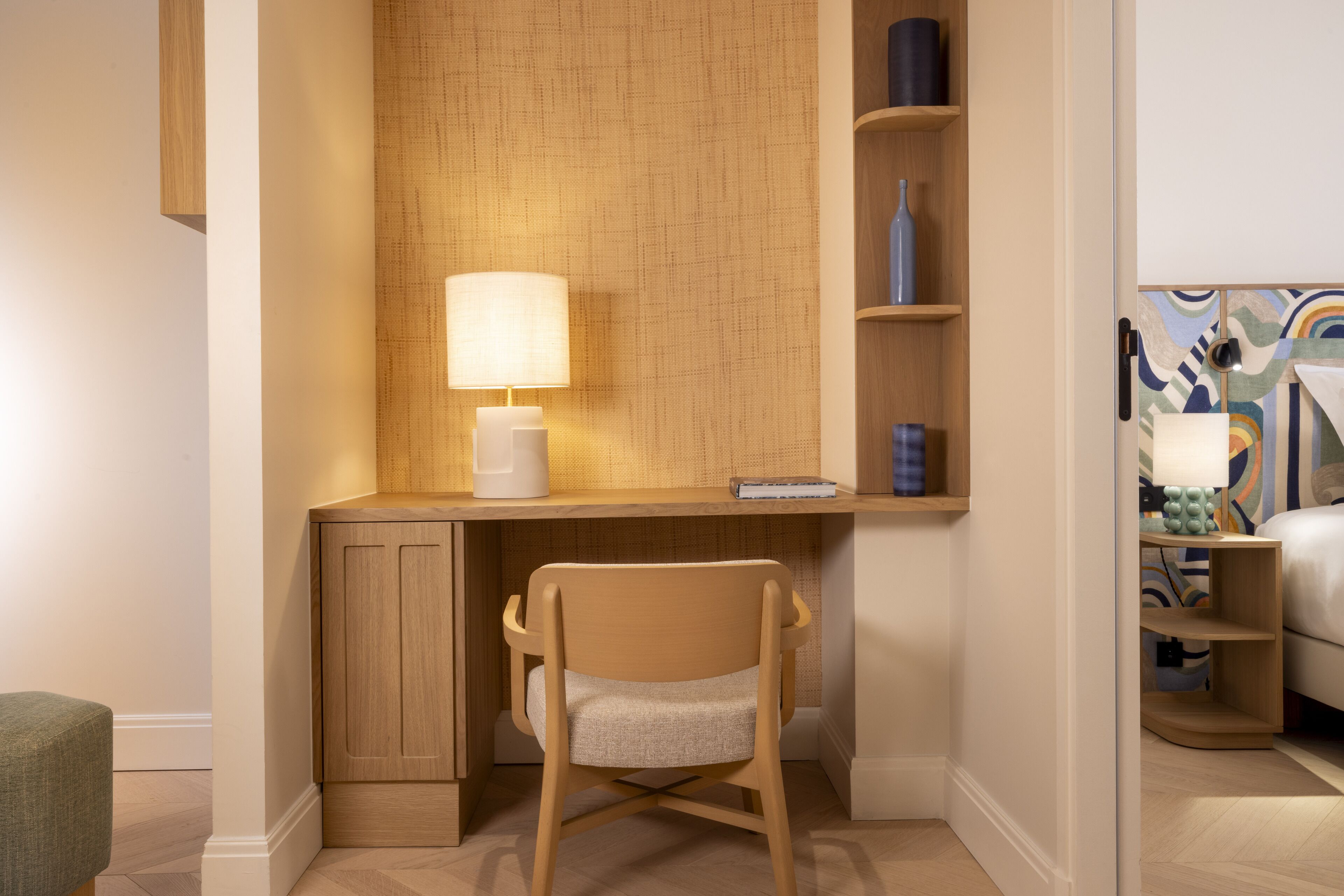 A compact workspace with a desk, chair, and shelving unit.