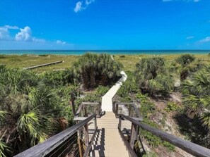 A wooden boardwalk leading to a beach with clear skies. - Welcome to THE HIVE. A hub for peace and relaxation. DIRECT GULF views (Placida)