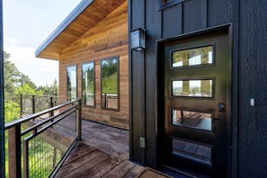 Guests can access their rooms through a secure keypad lock and enjoy a balcony with a railing.