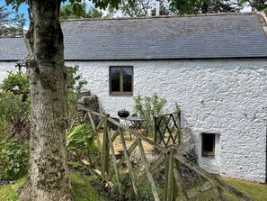 A rustic stone building with a wooden deck and a barbecue grill. - Beautiful 2BR Converted Mill - Idyllic Location - Pass the Keys (Dumfries)