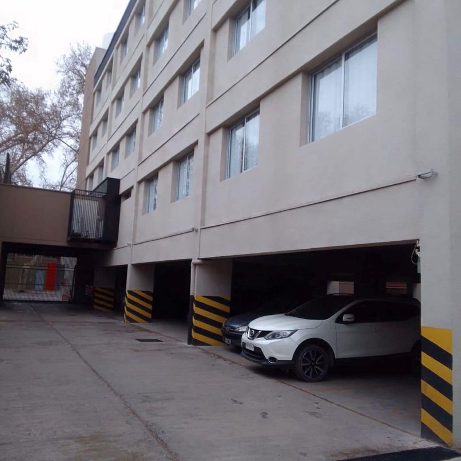 A multi-story parking garage with several cars parked.