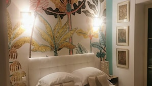 A bedroom with a large bed, two bedside tables, and a wall mural. - Blue Dream Cannes Guesthouse (Cannes)