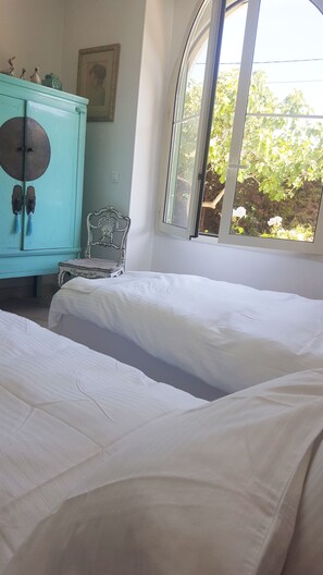 A bedroom with two beds, a window, a dresser, and a chair. - Blue Dream Cannes Guesthouse (Cannes)
