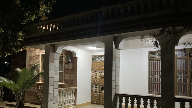 A traditional building with a covered porch, stone walls, and a tiled floor. - Marthie Homeaway (Dodoma)