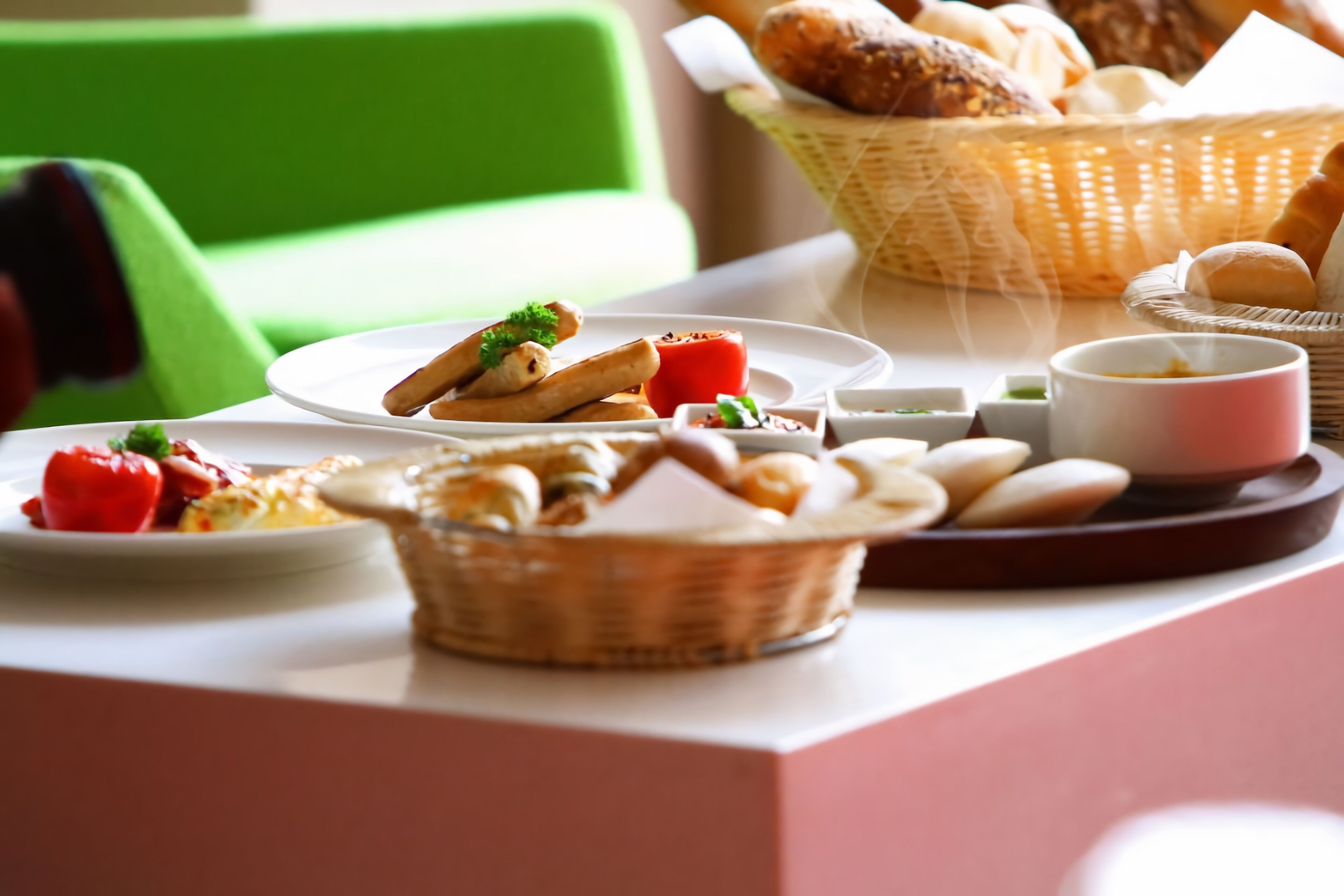 A breakfast table with various pastries, bread, and condiments.