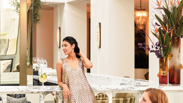 A modern interior with a dining area, a seating area with a sofa, and a bar counter. - Fairmont Hotel La Marina Rabat Sale (Salé)