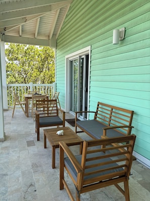 Relax in this inviting outdoor seating area with comfortable tables and chairs, perfect for taking in the surroundings.