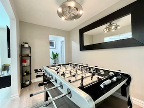 Relax and play in this stylish room, featuring a foosball table and cozy reading nook.