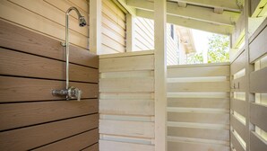 A wooden interior with a shower area, including a showerhead and faucet. - Wingspan: Modern, Elegant Home Close to the Intracoastal Waterway (Oak Island)