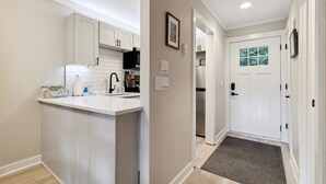 A modern kitchen with white cabinetry, a built-in microwave, and a stainless steel refrigerator. - Quiet MTN Home w/ Fireplace, Minutes to Banner Elk (Banner Elk)
