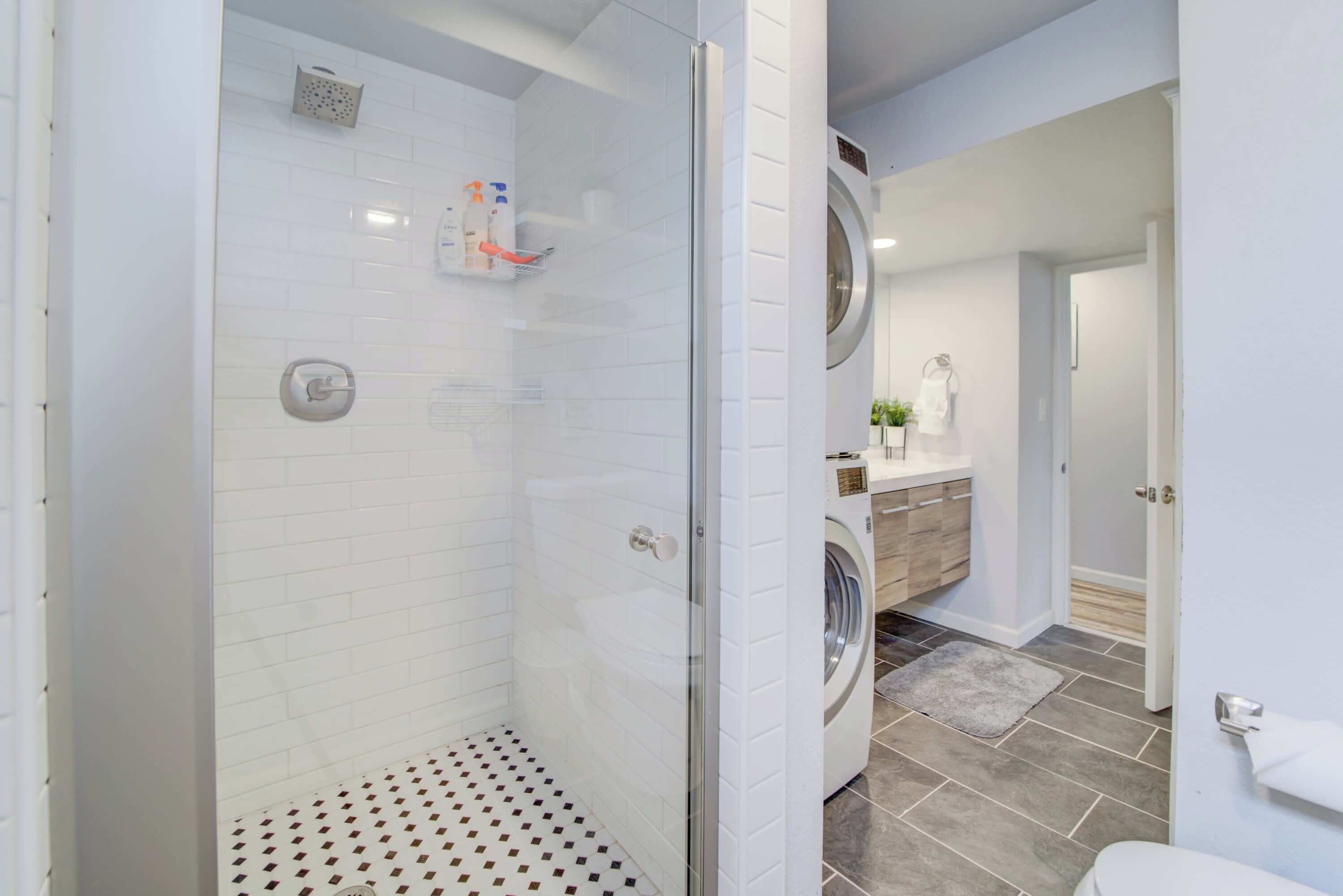 Bathtub, hair dryer, towels, shampoo