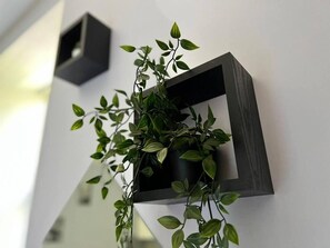 A modern wall-mounted planter with a plant. - Impeccable 2-bed Apartment by Cardiff City Centre (Cardiff)