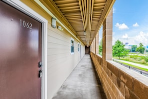 Guest rooms lead from this corridor, offering views of the surrounding landscape.