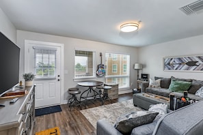 Relax in this stylish living space with a kitchen, dining area, and comfortable seating.