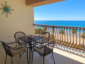 Enjoy the ocean view from this balcony with a table and chairs, perfect for taking in the sights.