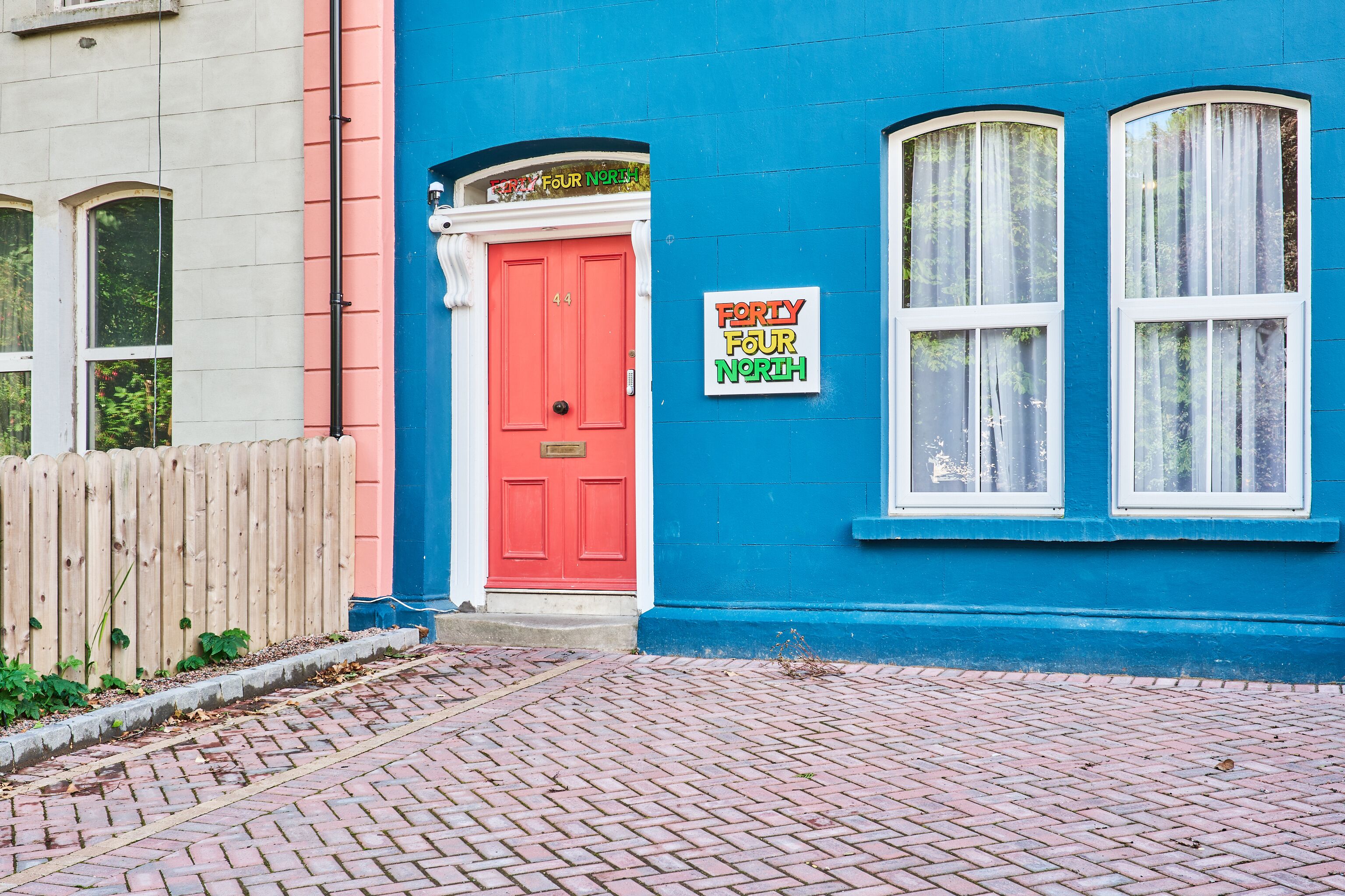 A building with a red door and a sign reading "Forty Four North."