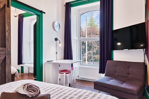 A room with a bed, a desk, a chair, and a window with curtains. - Forty Four North (Londonderry)