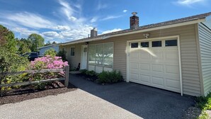 A single-story house with a garage, a front door, and a chimney. - Welcome home in a welcoming town! (Littleton)