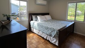 A bedroom with a bed, a desk, and a window. - Welcome home in a welcoming town! (Littleton)