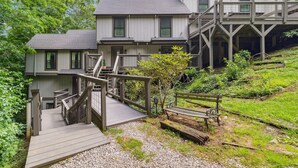 A multi-story building with a wooden deck and stairs leading to a balcony. - Quiet Mountain Home with Fireplace, A+ Location (Banner Elk)