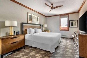 Classic hotel room with a large bed, bedside tables, and a television.