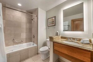 Bathroom features a walk-in shower, standalone bathtub, and double sink with a granite countertop.