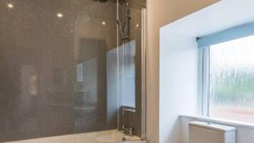 Combined shower/bathtub, deep-soaking bathtub, hair dryer, towels