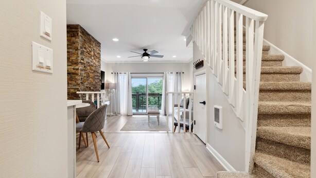 A modern interior with a staircase, a dining area, and a view to the outdoors. - Peaceful MTN Haven with Fireplace & Views (Banner Elk)