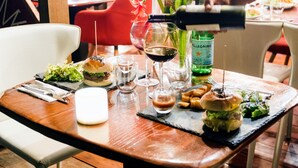 A dining table with a variety of food items and glasses of wine. - Villa F&B (Bastimentos)