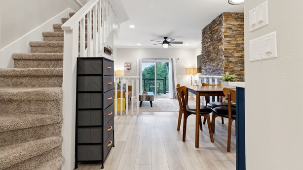 A modern kitchen with a dining area, a staircase, and a view to the outdoors. - Quiet Mountain Home with Fireplace, A+ location! (Banner Elk)
